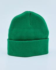 Green beanie on a light blue background