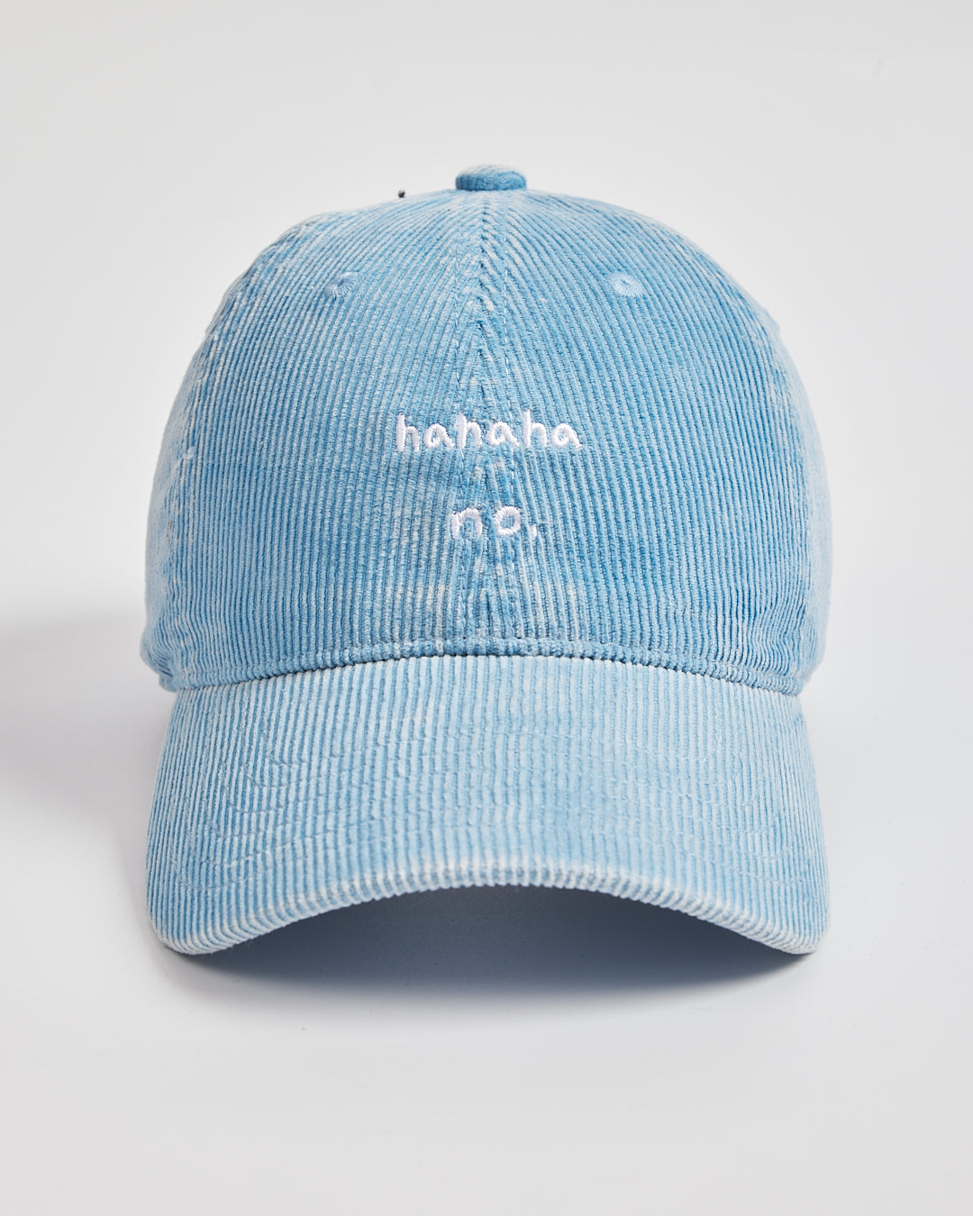 Light blue corduroy cap with 'hahaha no.' text on a white background