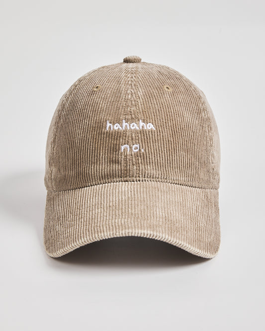 Beige corduroy cap with 'hahaha no.' text on a light gray background