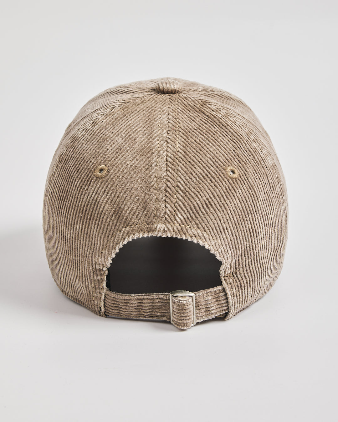 Beige corduroy cap on a light gray background