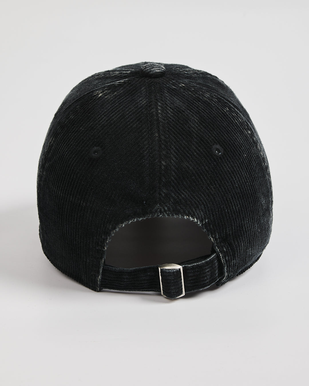 Black cap with a textured surface on a white background