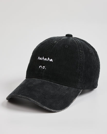 Black corduroy cap with white text on a light gray background
