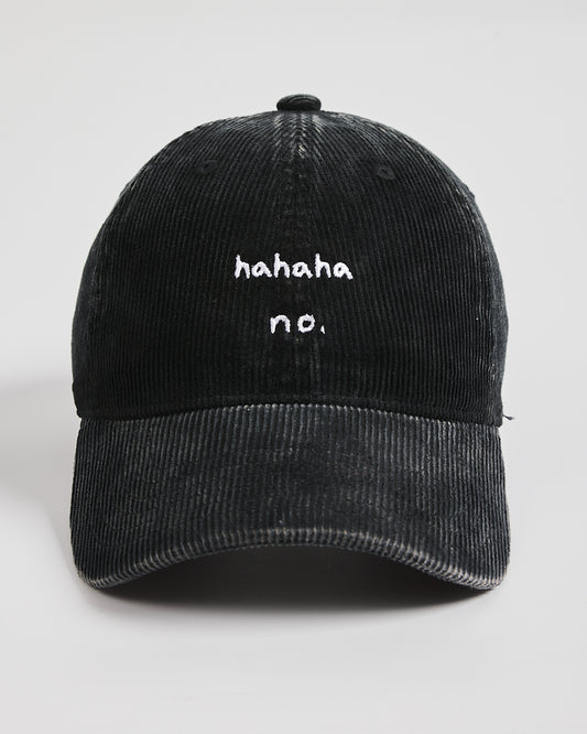 Black corduroy cap with 'hahaha no.' text on a white background