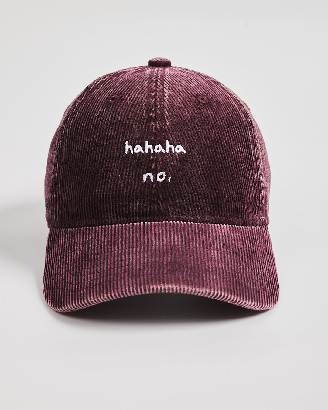 Hahaha No Burgundy Corduroy Cap with 'hahaha no.' text on a light gray background