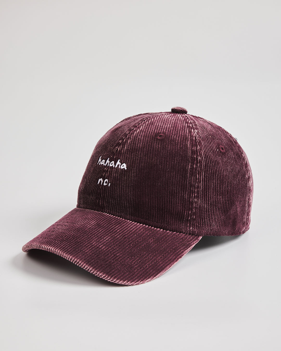 Hahaha No Burgundy Corduroy Cap with white text on a light gray background