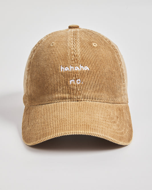 Camel yellow corduroy cap with 'hahaha no.' text on a light gray background