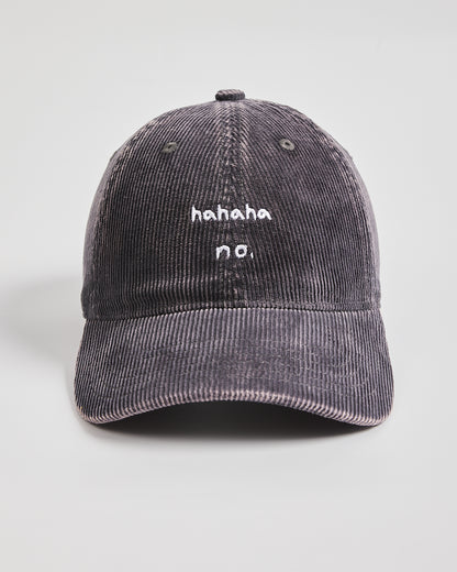 Charcoal grey corduroy cap with 'hahaha no.' text on a light gray background