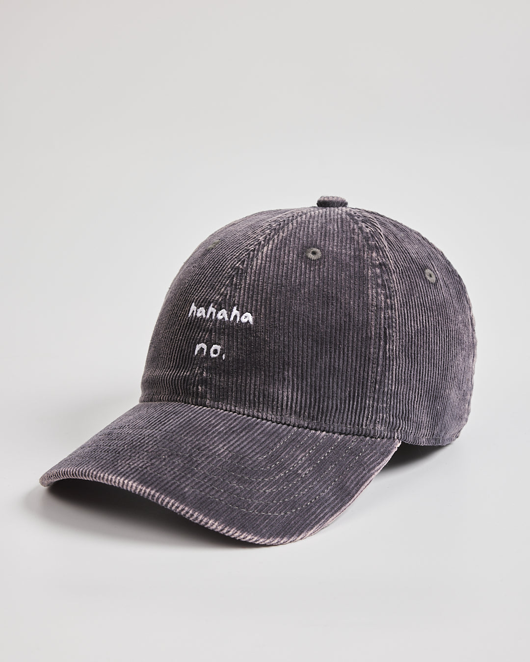Charcoal grey corduroy cap with text on a light gray background