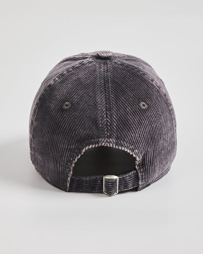 Charcoal grey corduroy cap on a light gray background