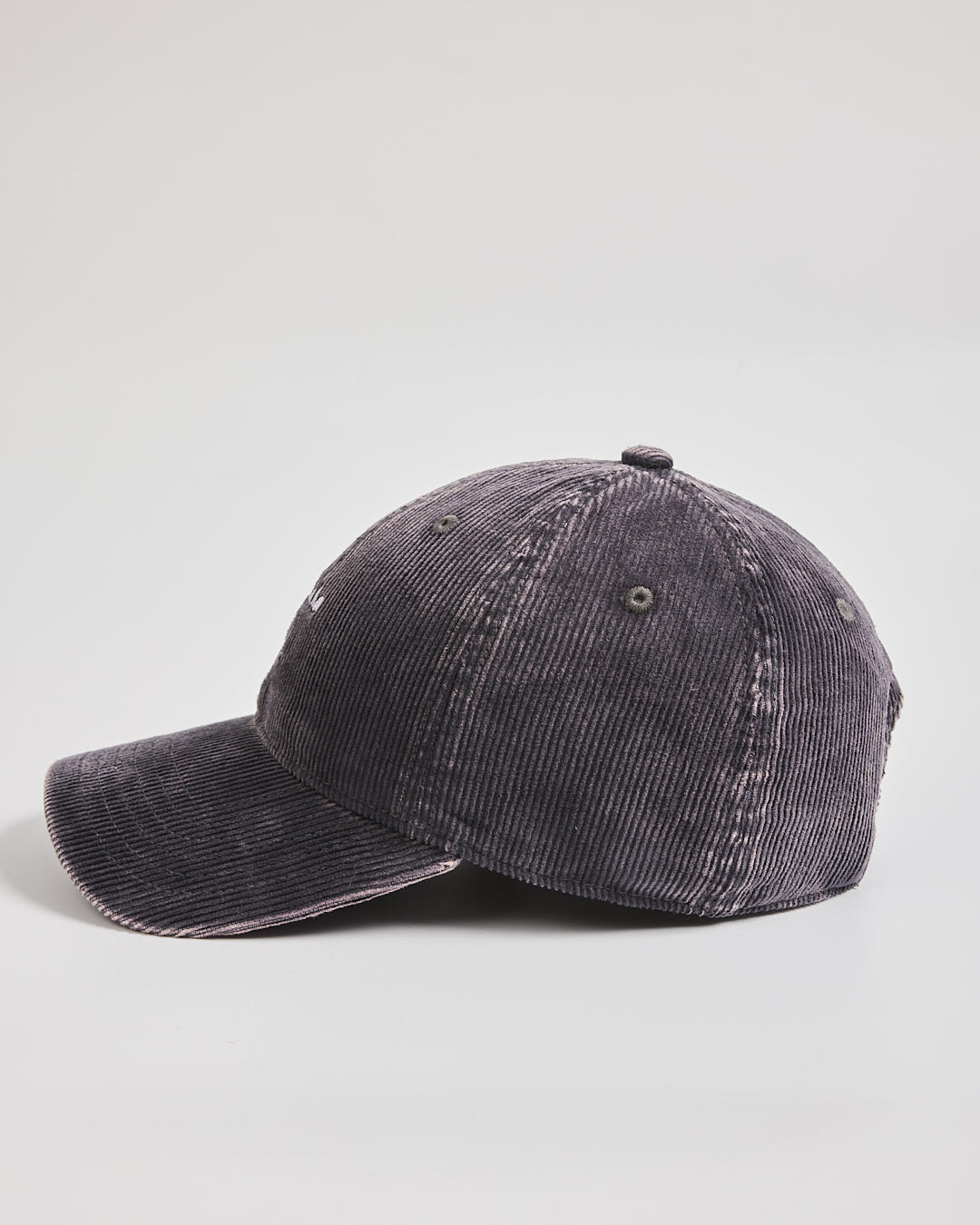 Charcoal grey corduroy cap on a light gray background