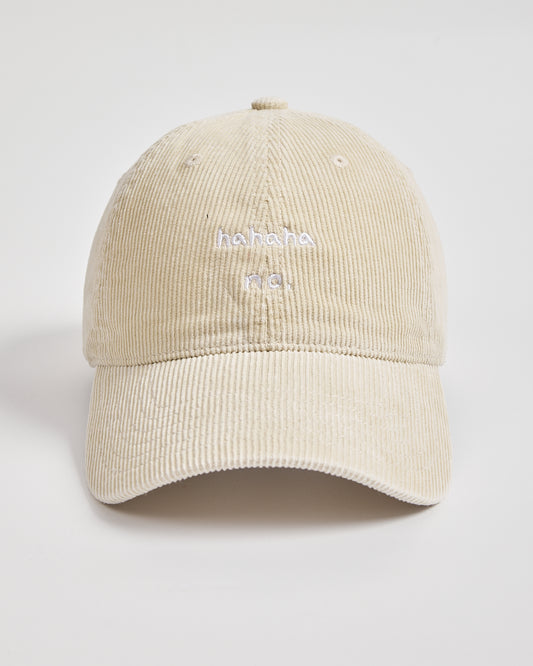 Beige cream corduroy cap with white text on a light gray background