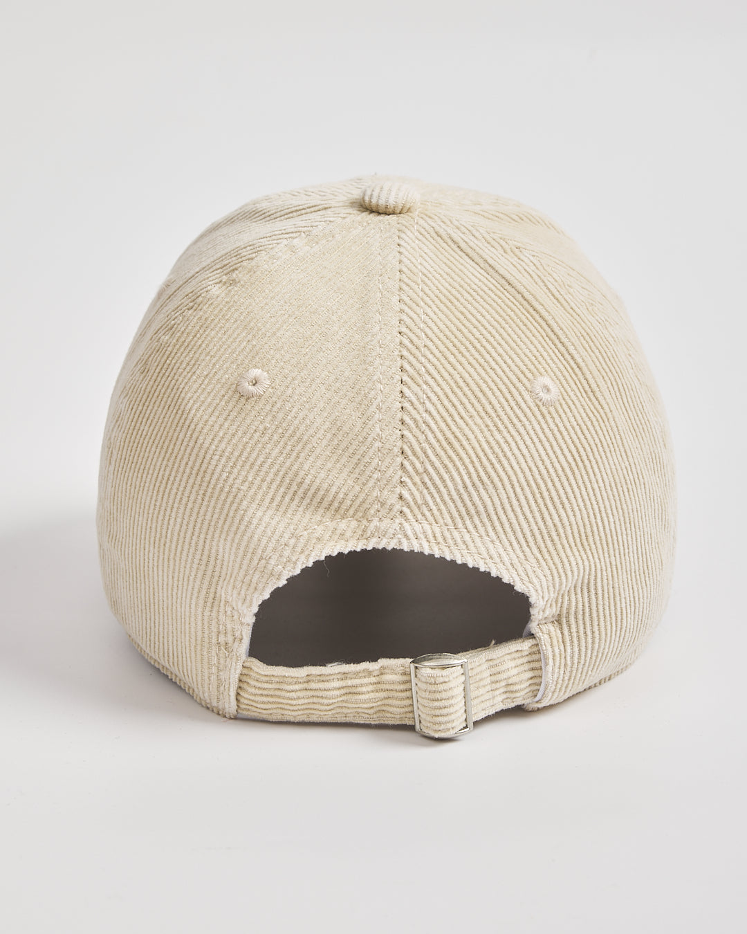 Beige corduroy cap on a light gray background