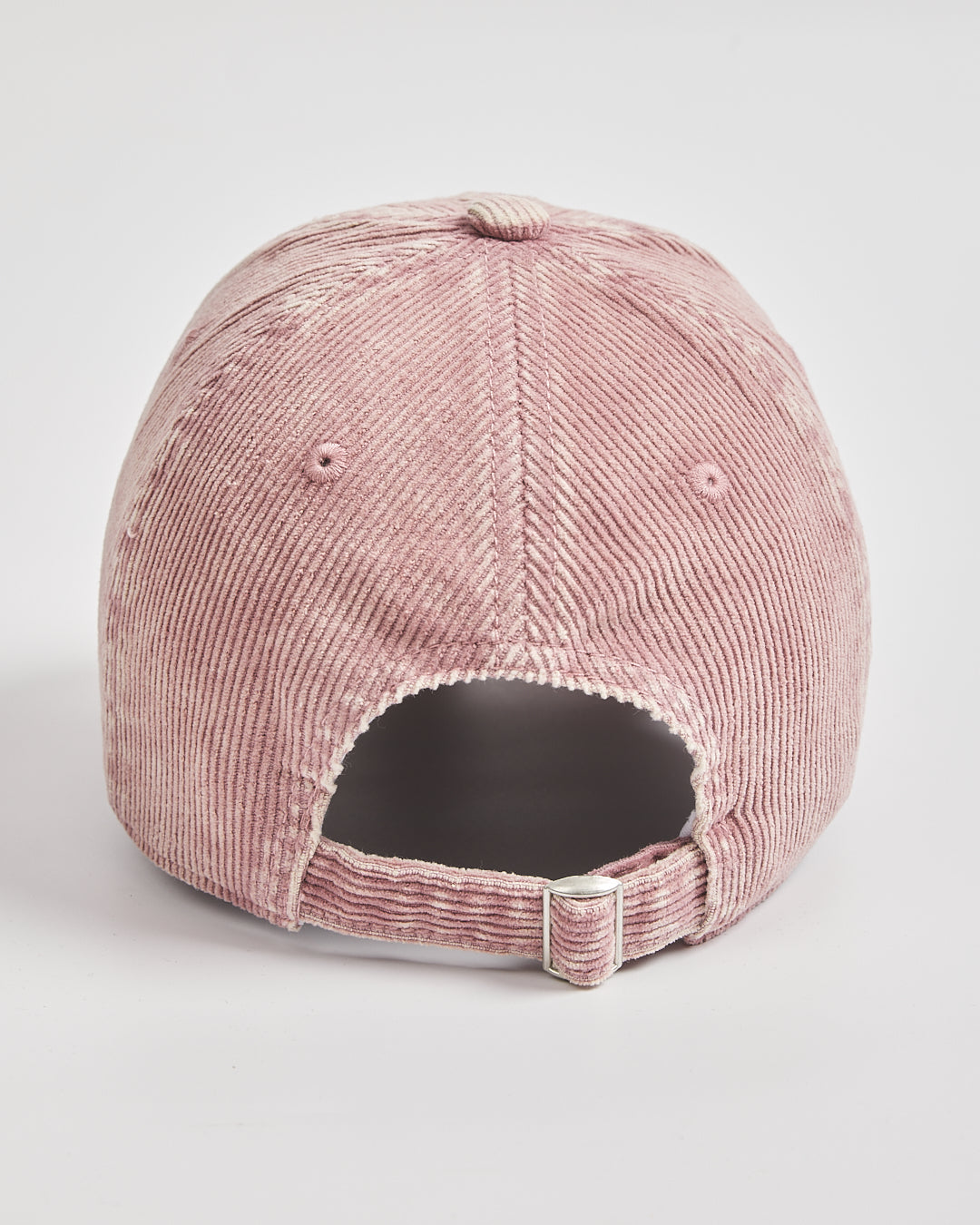 Pink corduroy cap on a light gray background