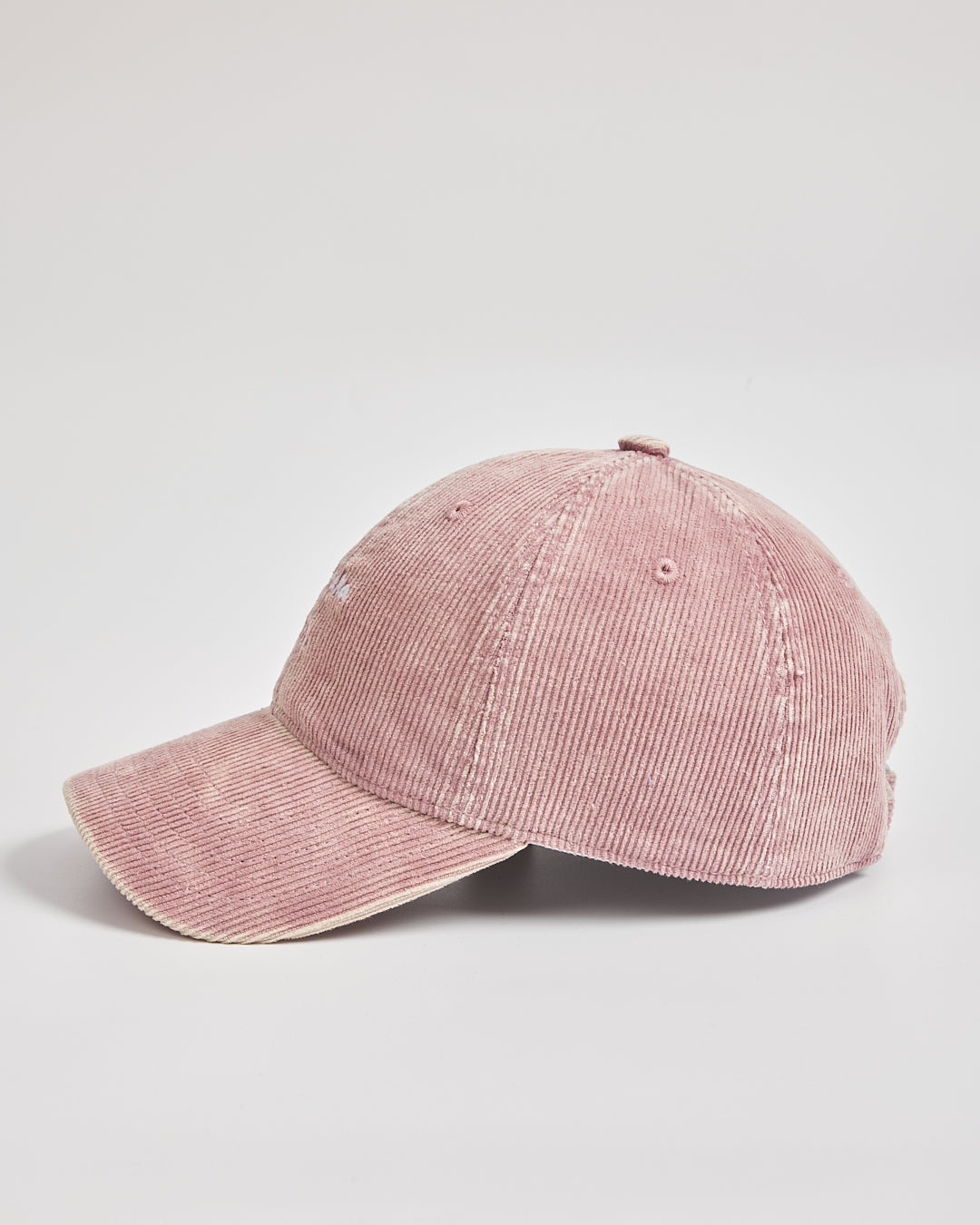 Pink corduroy cap on a light gray background