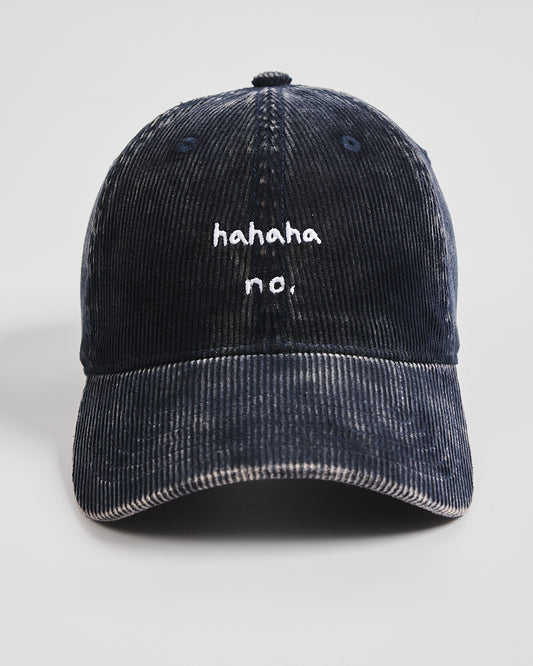 Navy blue corduroy cap with 'hahaha no.' text on a light gray background