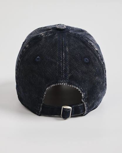 Navy blue corduroy cap distressed baseball cap on a white background