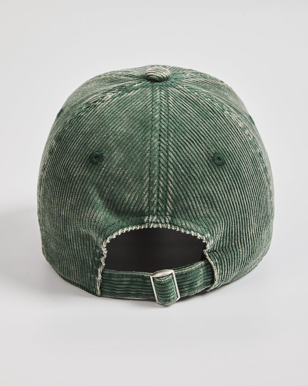 Green corduroy cap on a light gray background