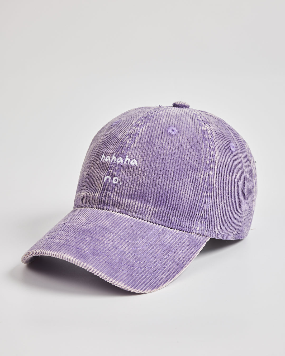 Purple corduroy cap with text on a light gray background