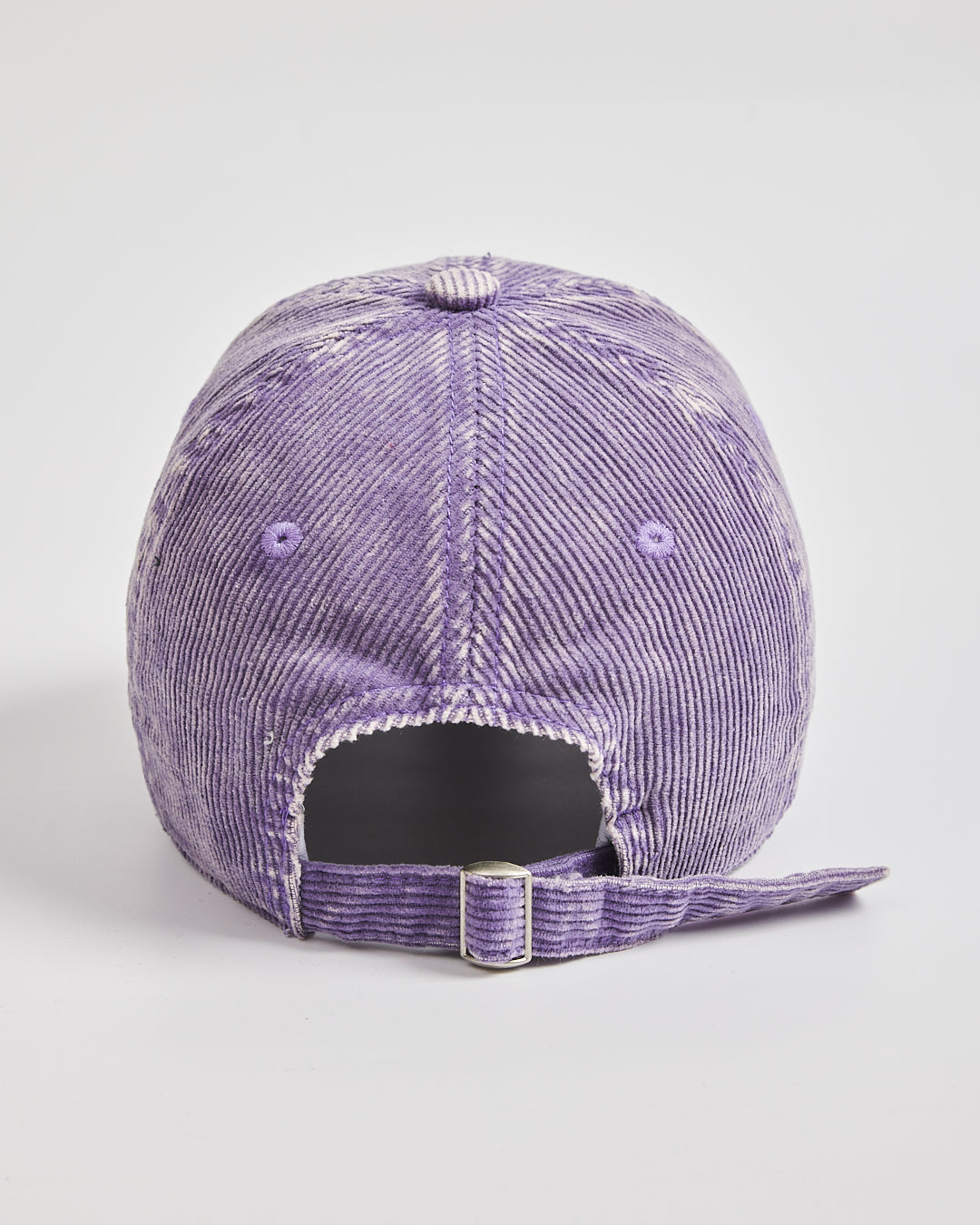 Purple corduroy cap on a light gray background
