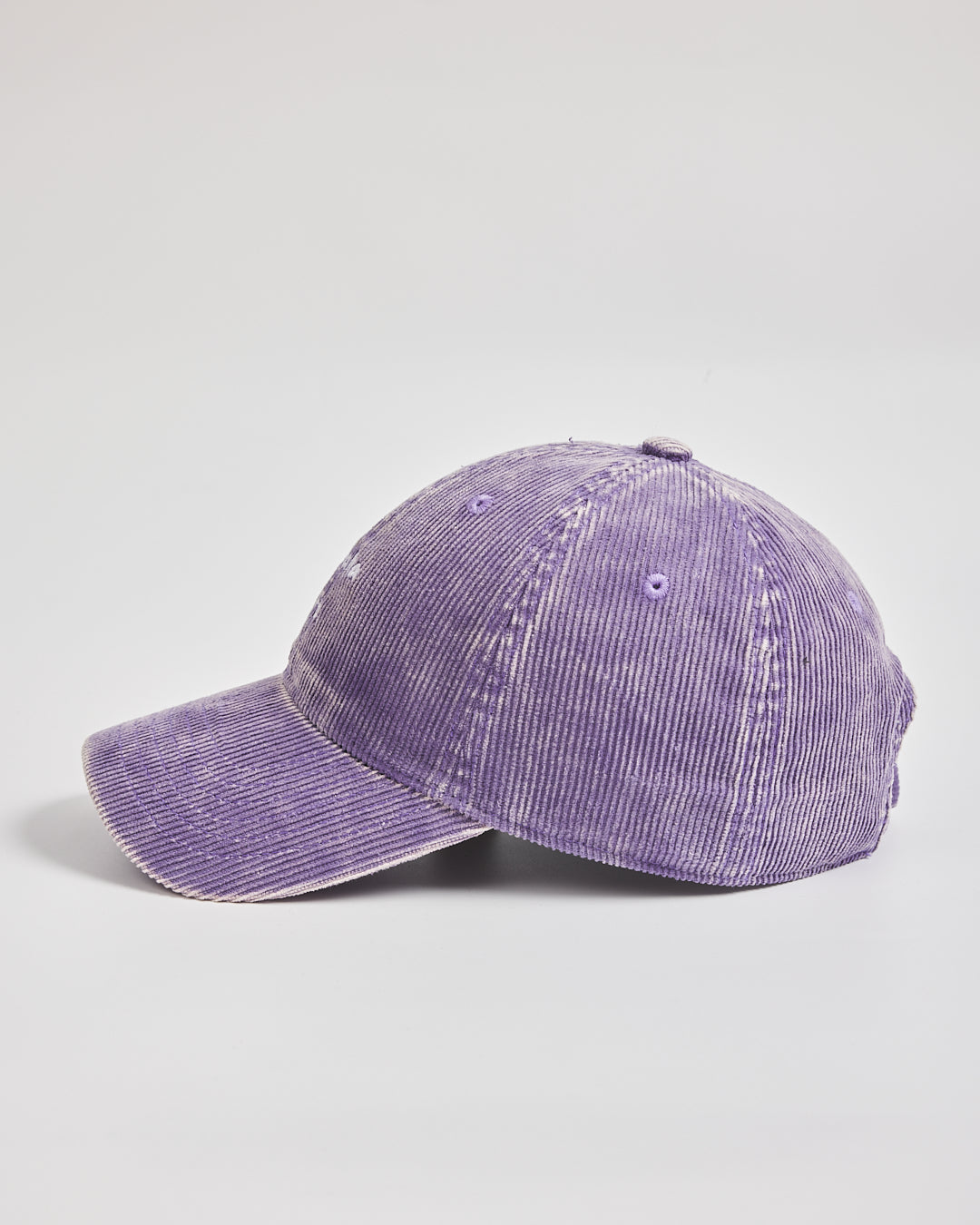 Purple corduroy baseball cap on a light gray background