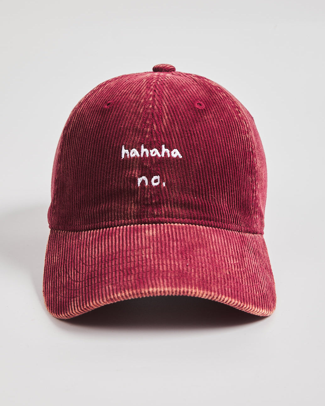 Hahaha No Red Corduroy Cap with white text on a light gray background
