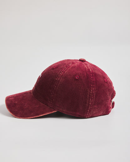 Red corduroy cap on a light gray background
