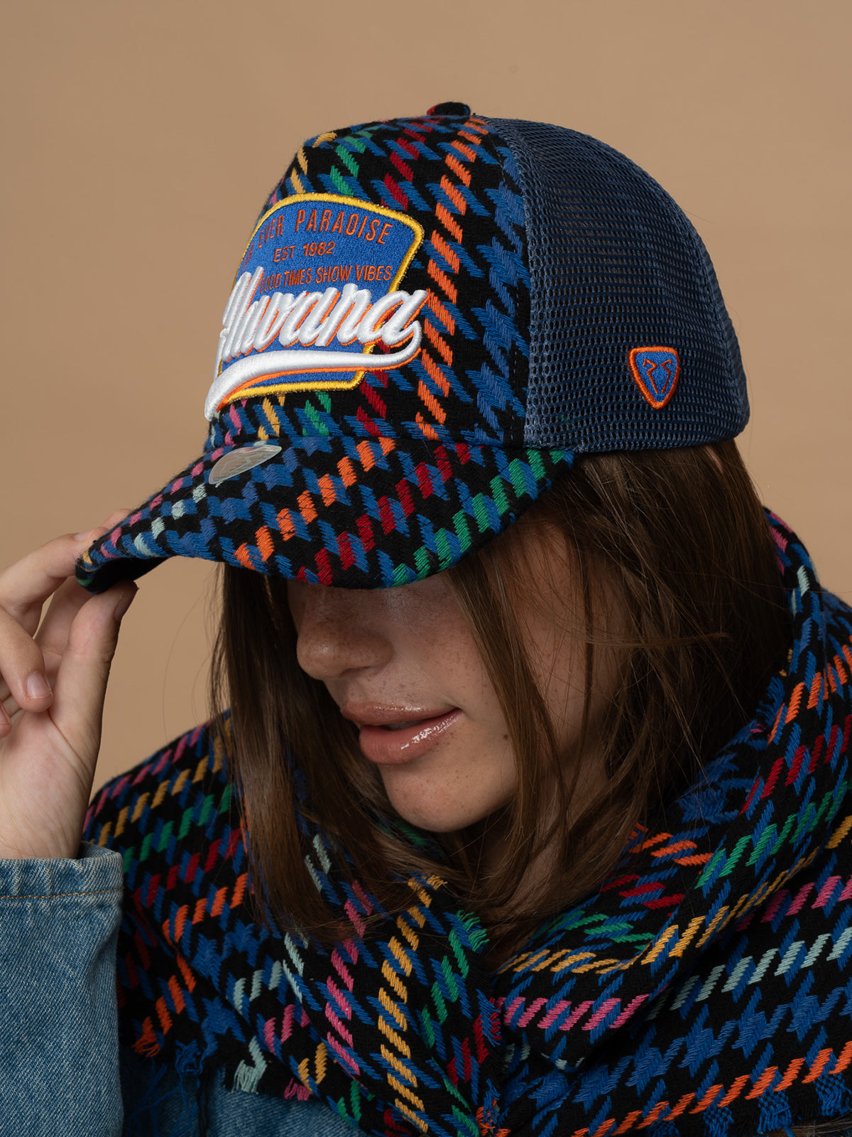 Person wearing Havana Indigo Trucker Hat against a brown background