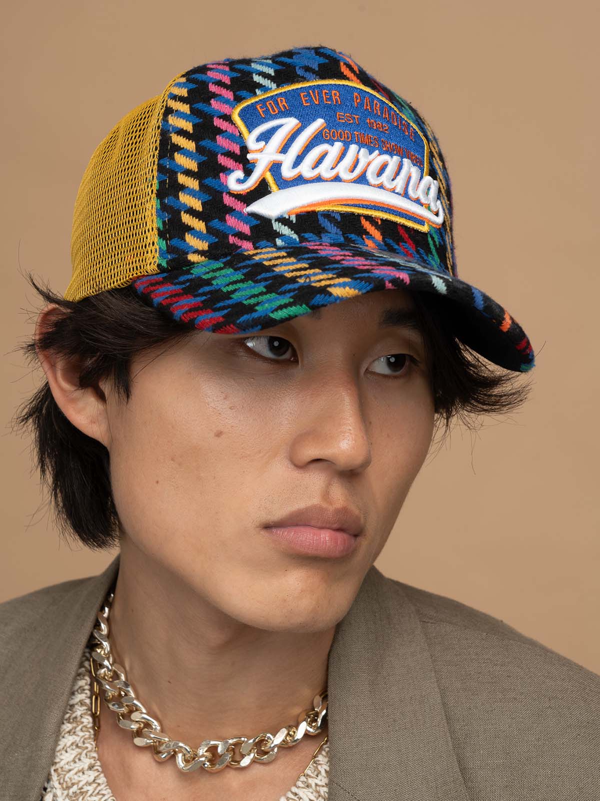 Person wearing Havana Yellow Trucker Hat on a beige background