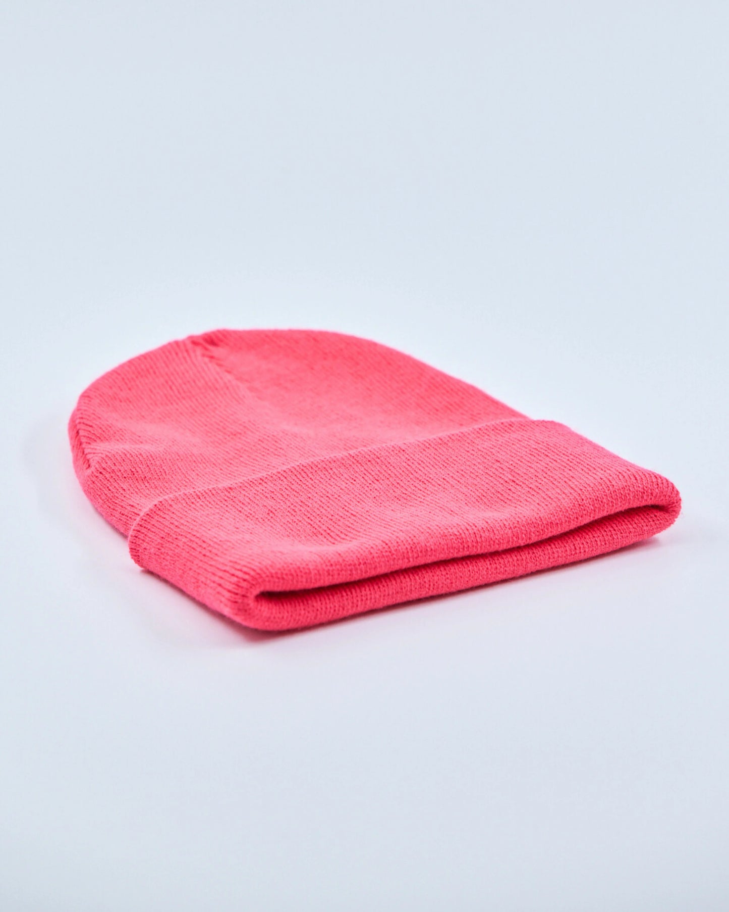 Hot pink beanie on a light gray background