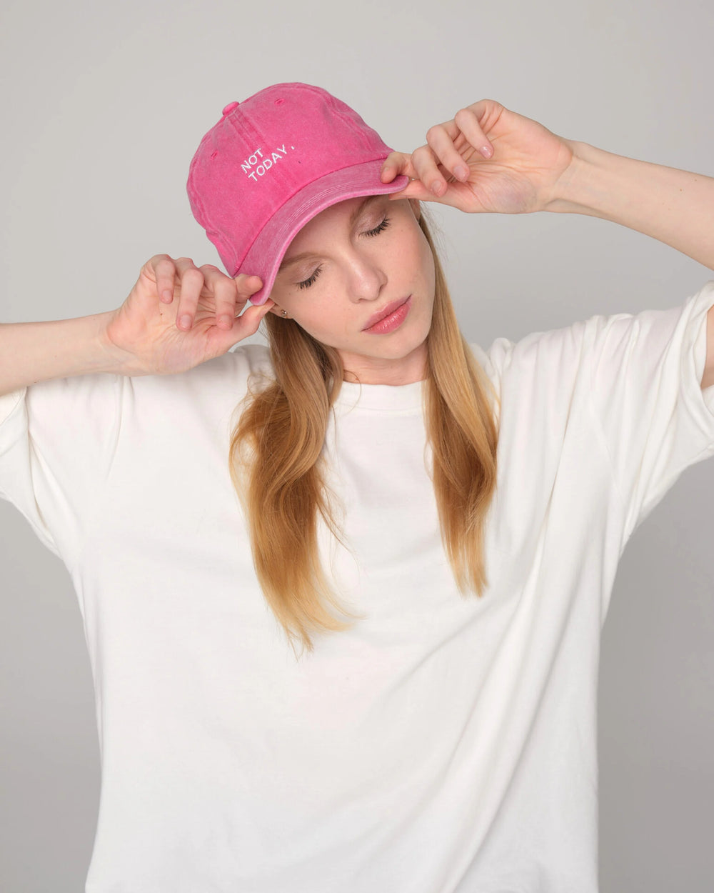 woman holding Hot Pink Washed Cap with Not Today embroidered in white