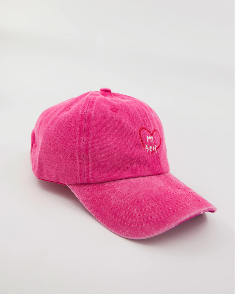 side view of hot pink washed cap with love myself embroidered in white