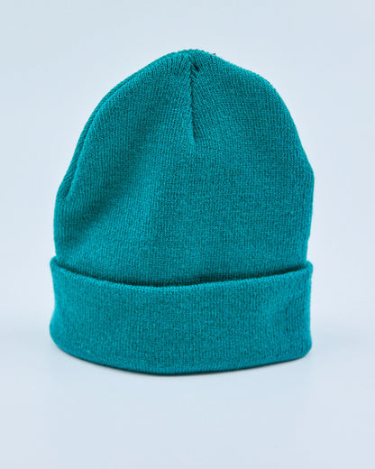Teal beanie on a light blue background