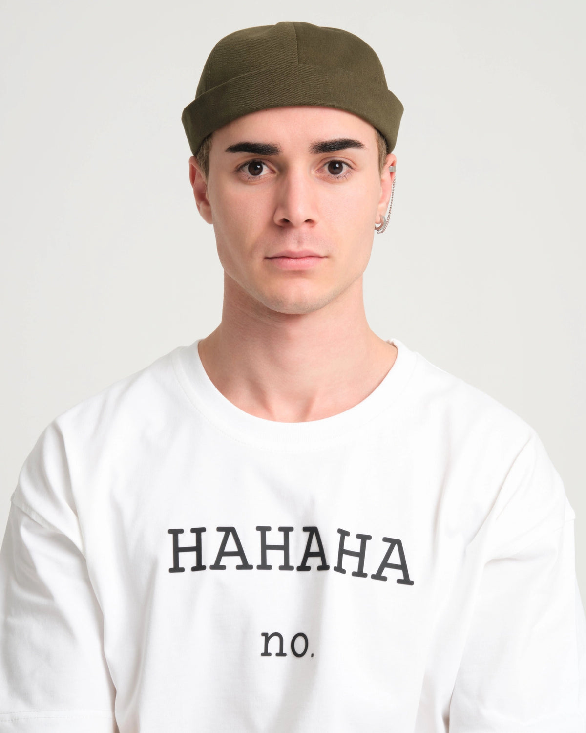 man wearing khaki docker cap
