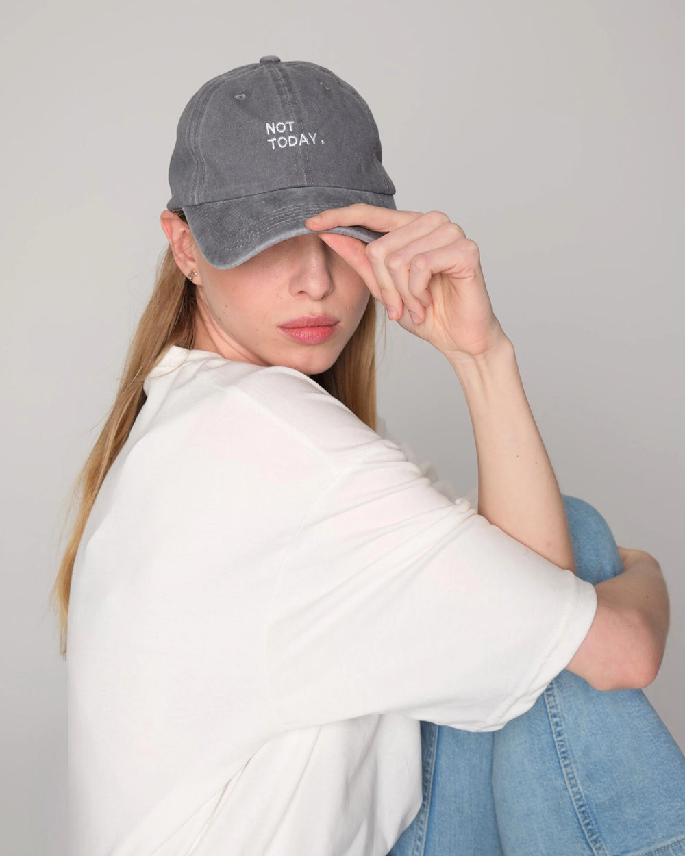 woman wearing and holding Light Gray Washed Cap with Not Today embroidered in white