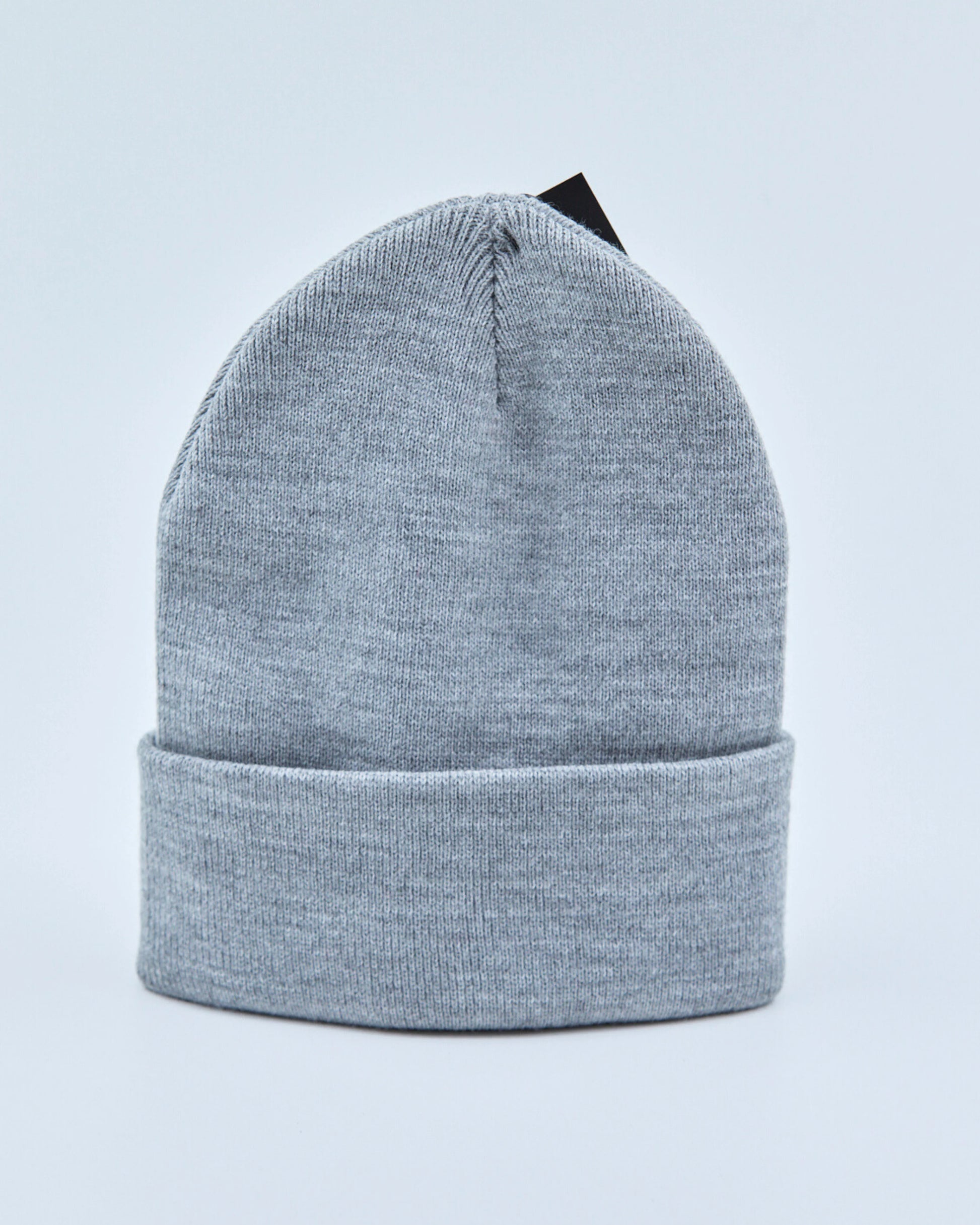 Light gray beanie on a light blue background