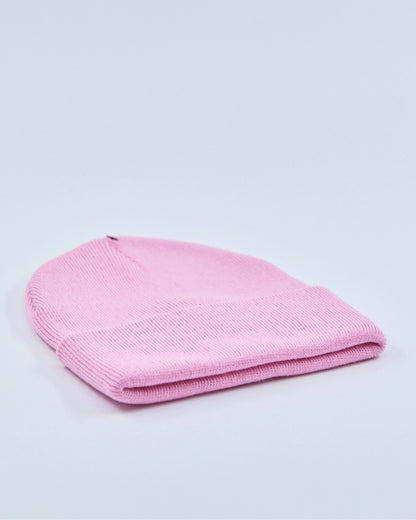 Light pink beanie hat on a light gray background