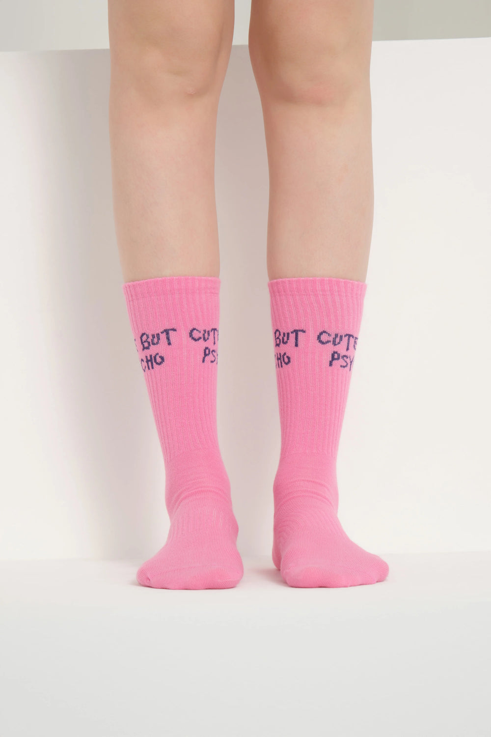 front view of pink cute but psycho socks
