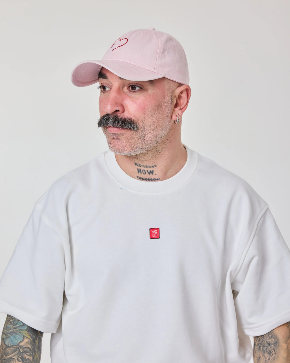 man wearing light pink love myself washed cap 