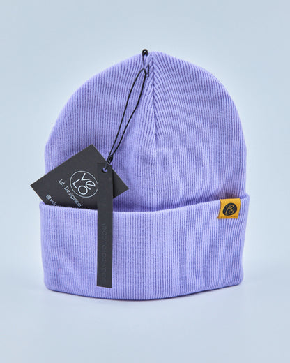 Lilac purple beanie with a brand tag on a light purple background