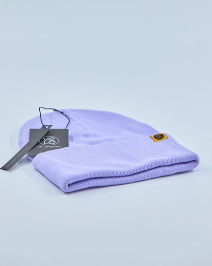 Purple beanie with a tag on a light blue background