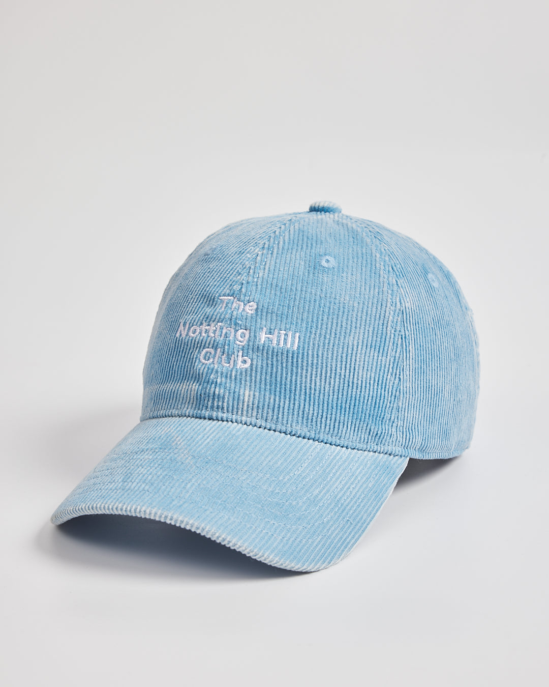 Light blue cap with 'The Notting Hill Club' text on a light gray background