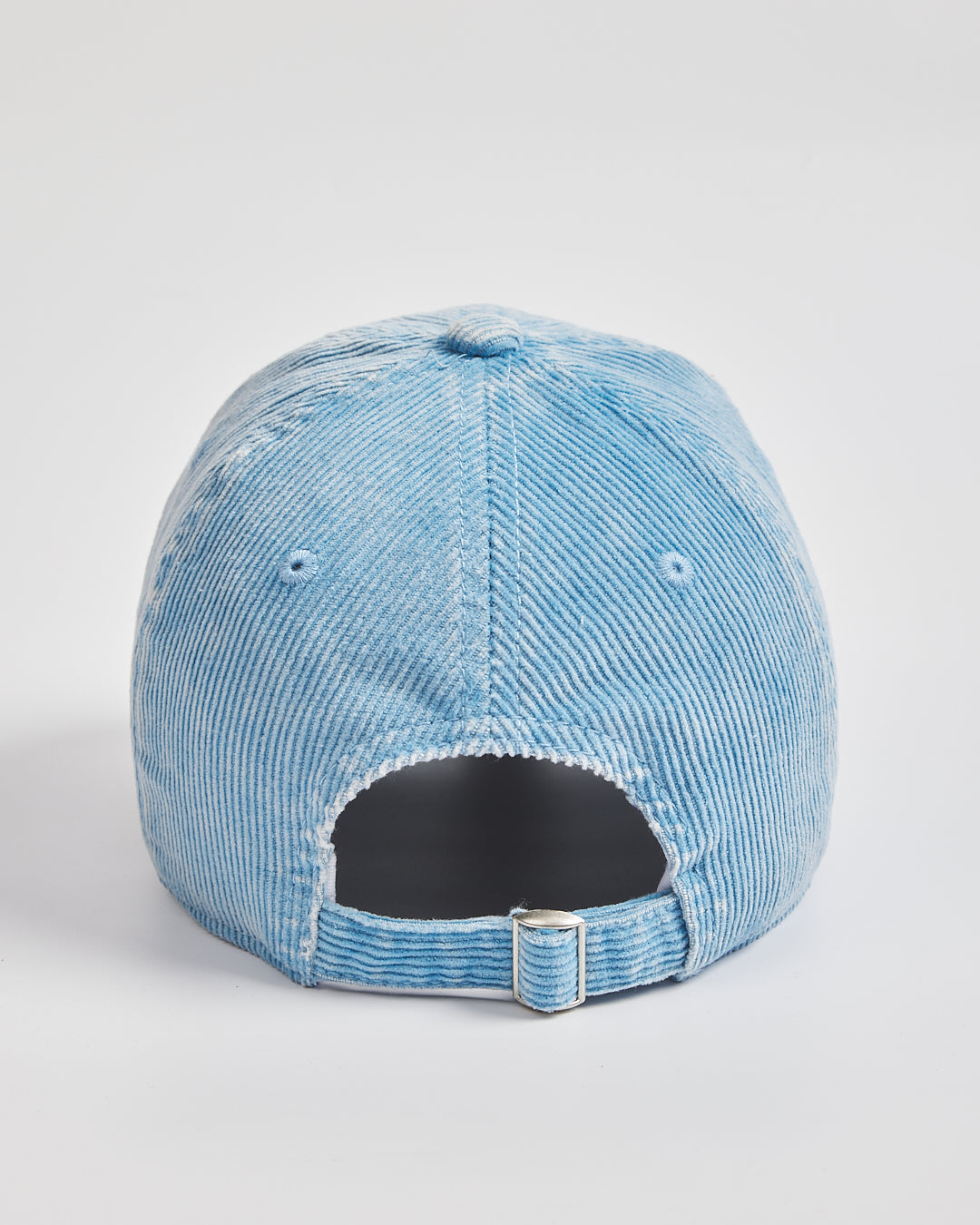Blue distressed baseball cap on a light gray background