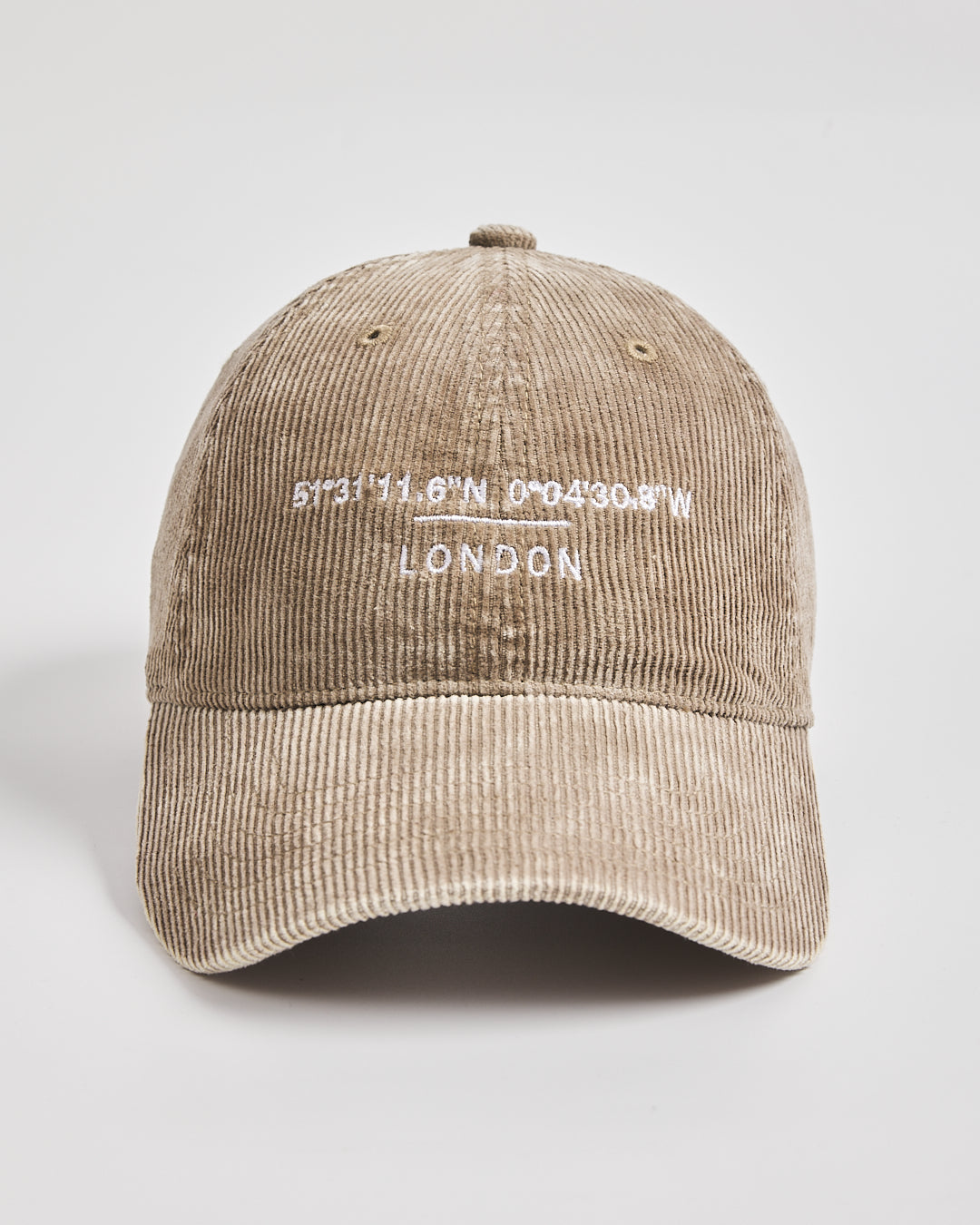 Beige corduroy cap with white text on a light gray background
