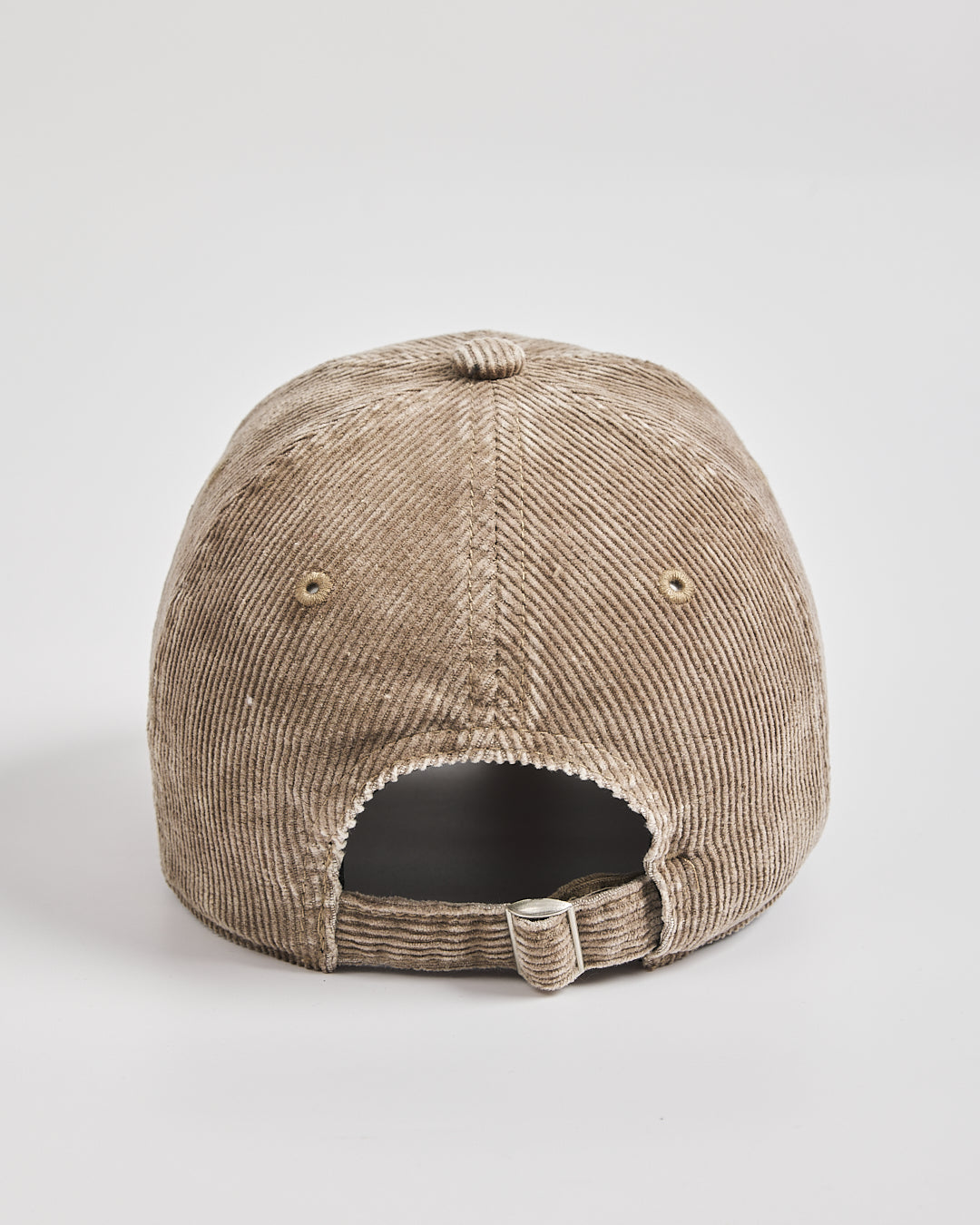 Beige corduroy cap on a light gray background