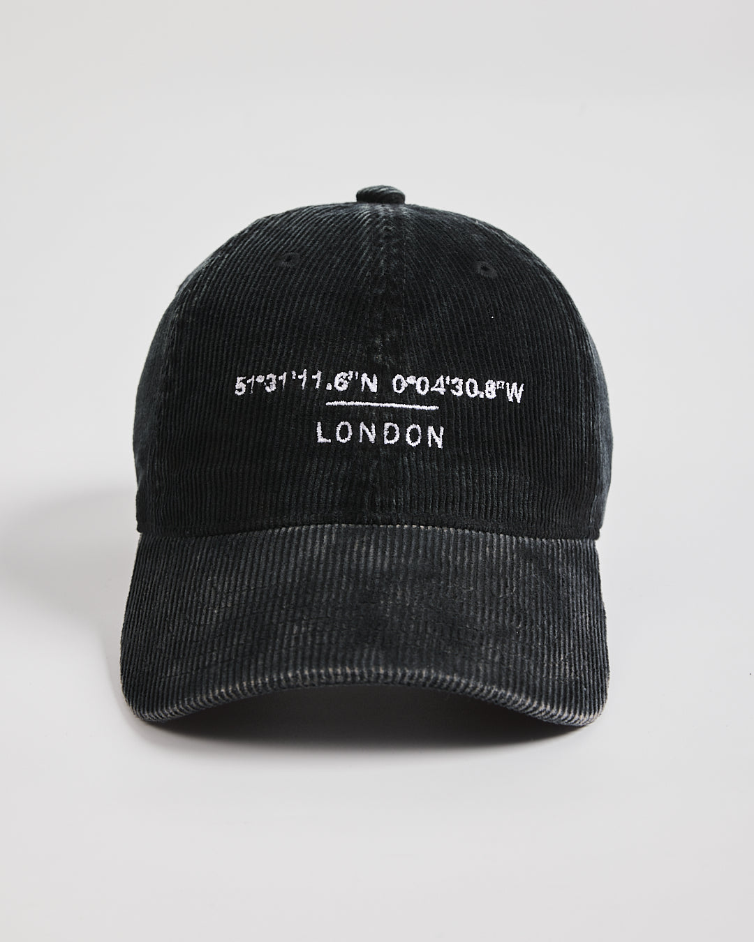 Black cap with white text on a light gray background