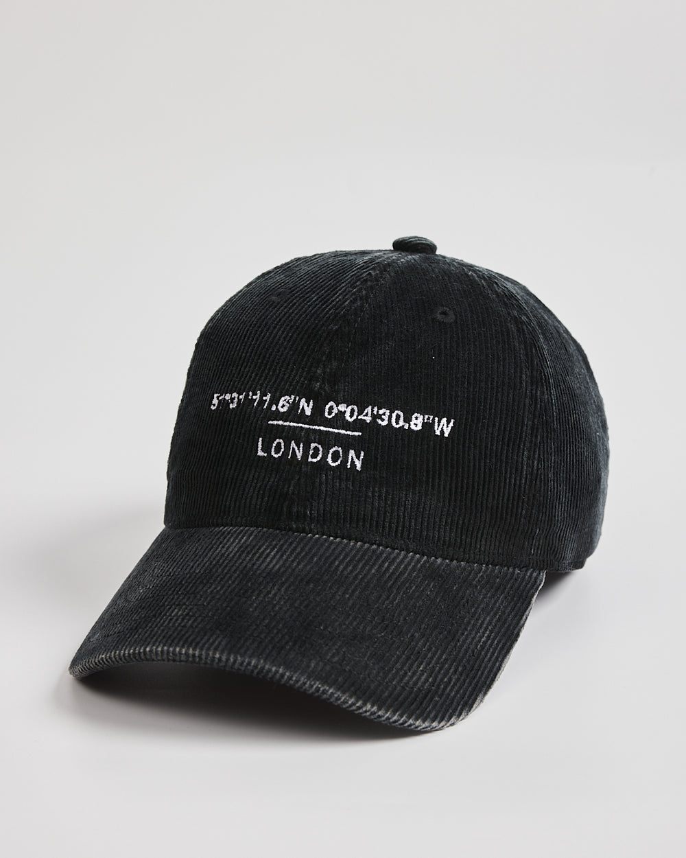 Black cap with white text on a light gray background