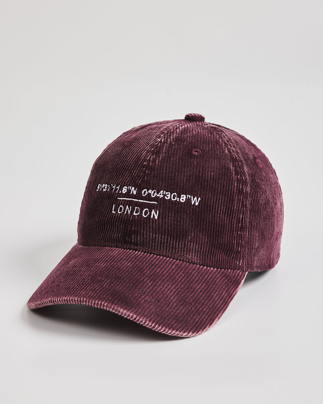 Maroon cap with 'London' and coordinates text on a light gray background