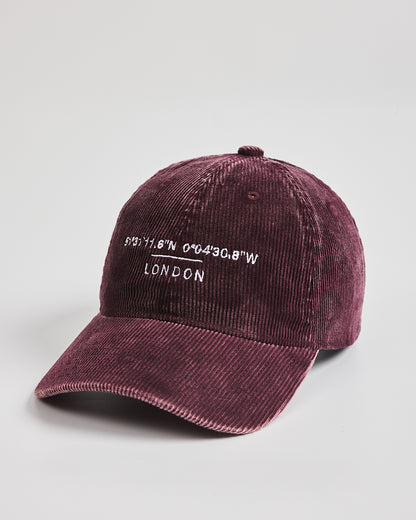Maroon cap with 'London' and coordinates text on a light gray background