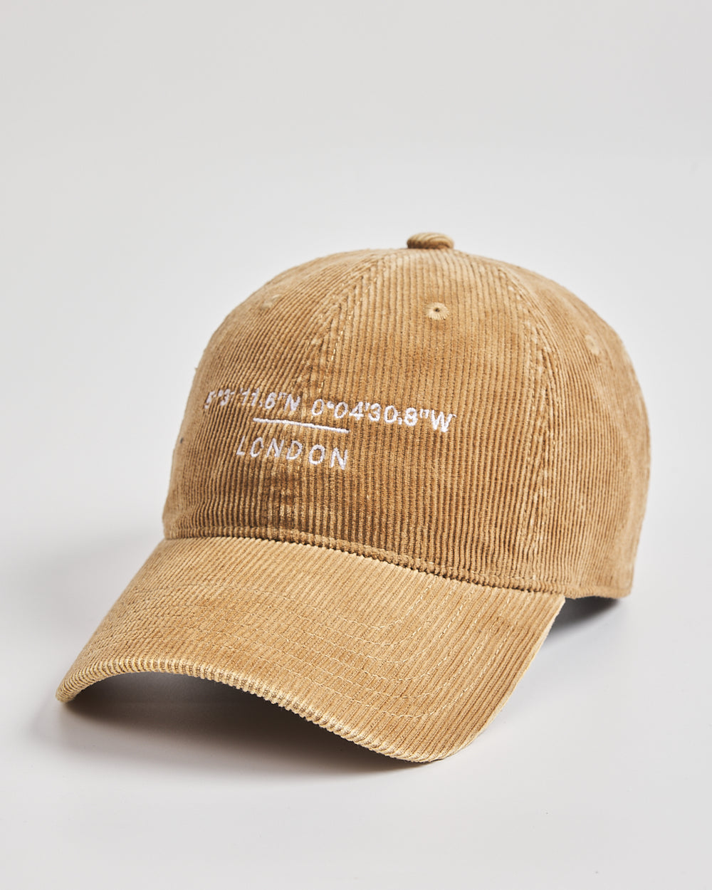 Camel corduroy cap with text on a light gray background