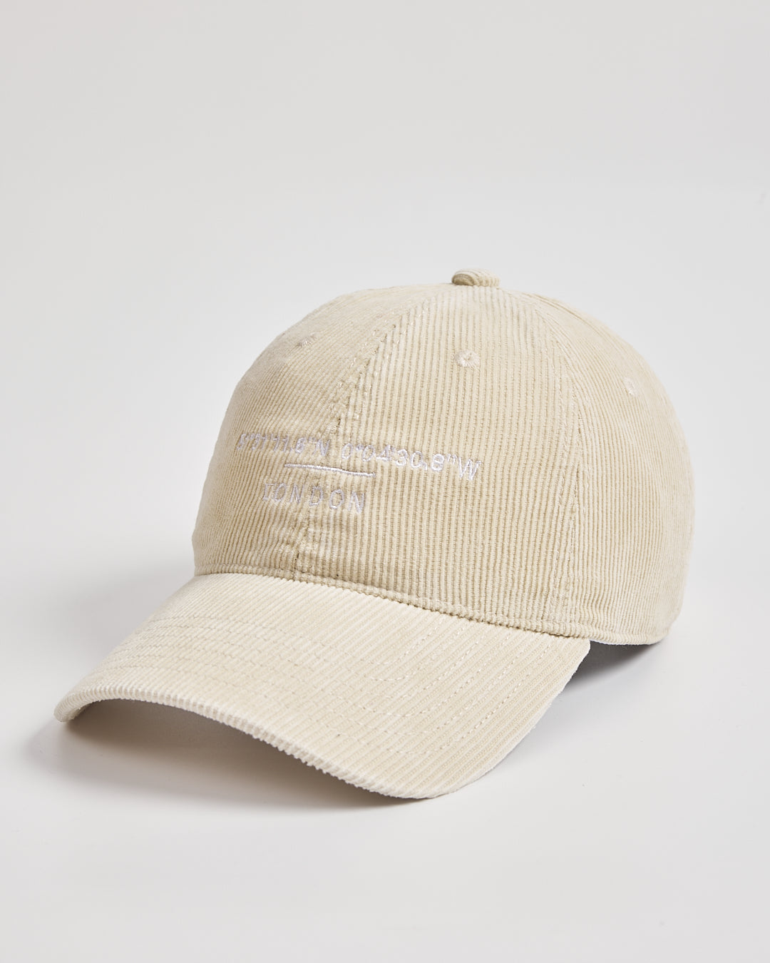 Cream corduroy cap on a light gray background